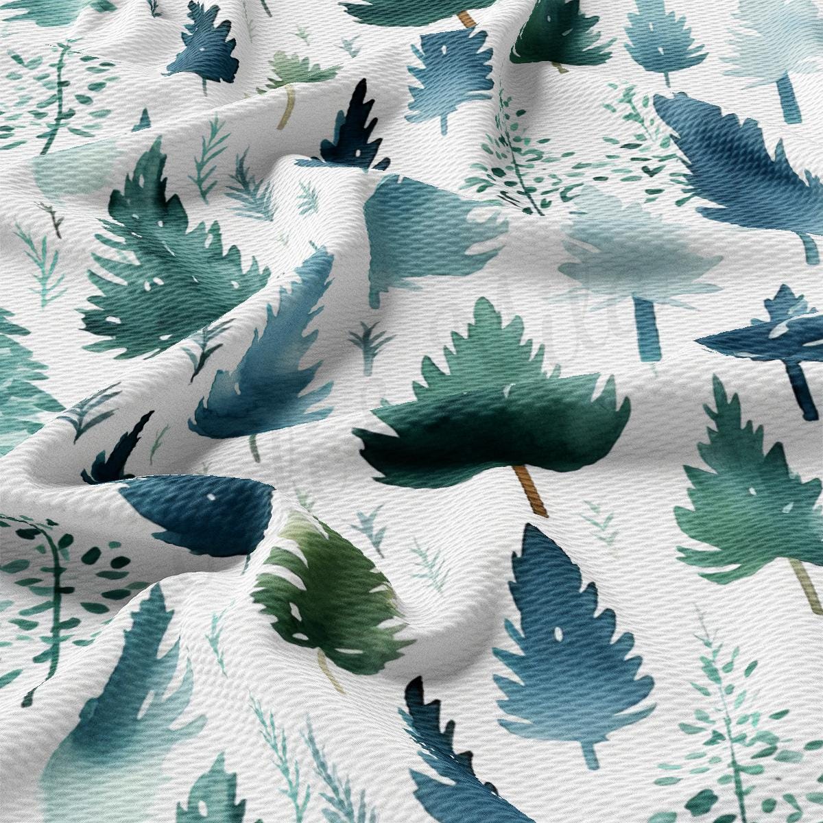 a white fabric with green leaves on it