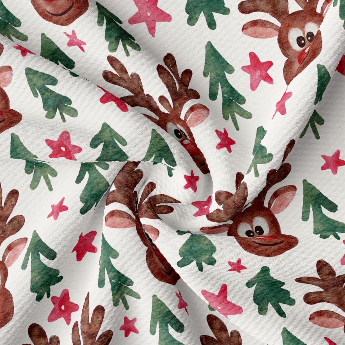 a close up of a white fabric with reindeers on it