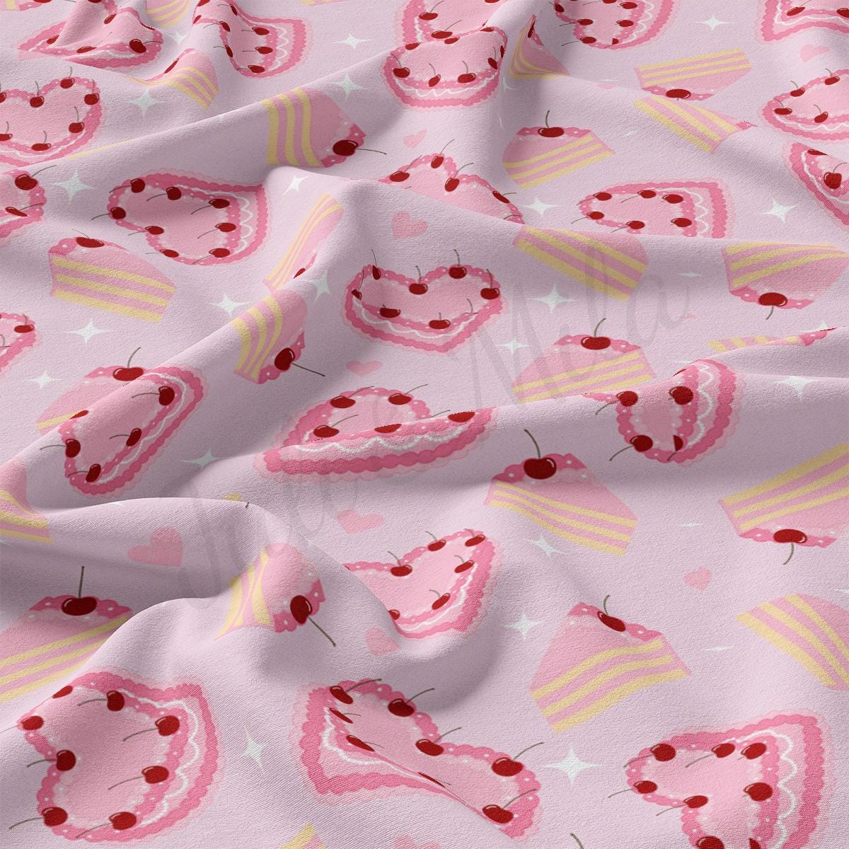 a pink fabric with cherries and cupcakes on it