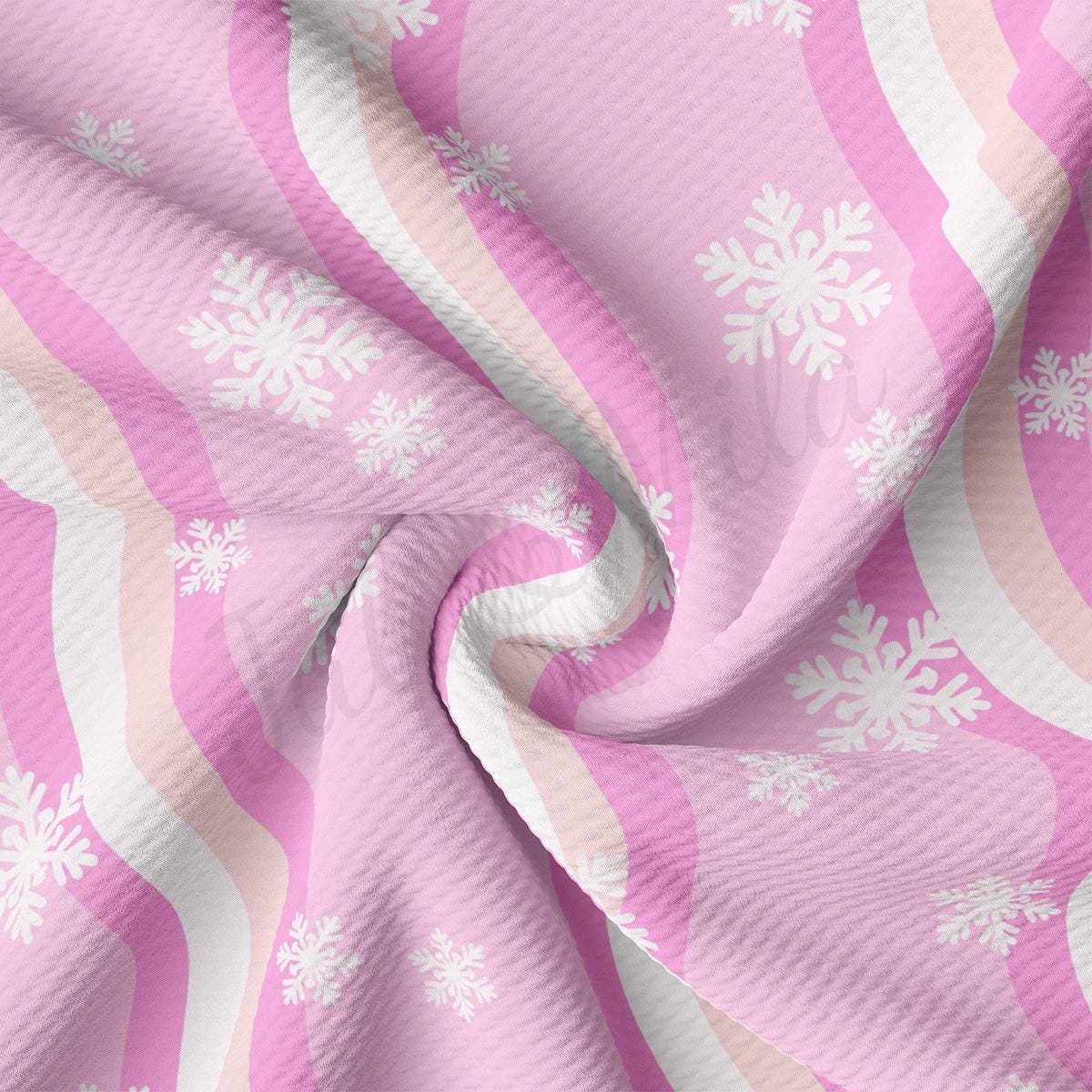 a pink and white fabric with snowflakes on it