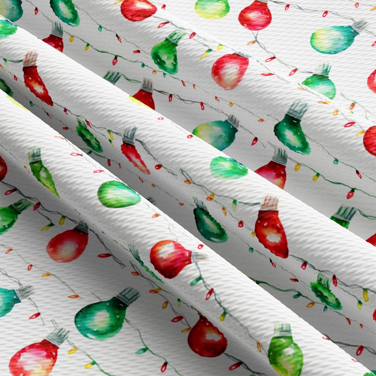 a close up of a white curtain with christmas lights on it